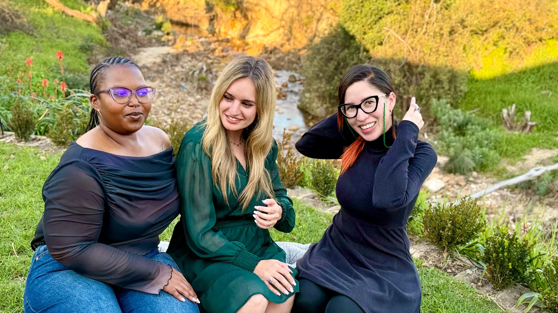 The practitioners laughing together outdoors.